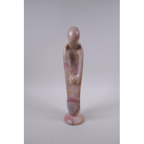 137 - A Kenyan carved and polished Kisii stone figure group in the form of a mother and child, 23cm high