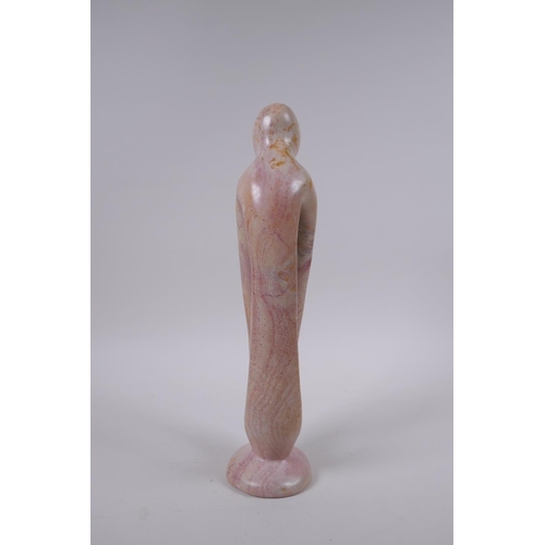 137 - A Kenyan carved and polished Kisii stone figure group in the form of a mother and child, 23cm high