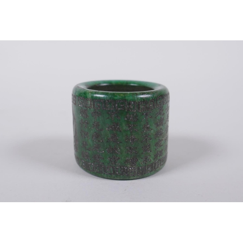 143 - A Chinese marbled green hardstone archers thumb ring, decorated with an allover character inscriptio... 