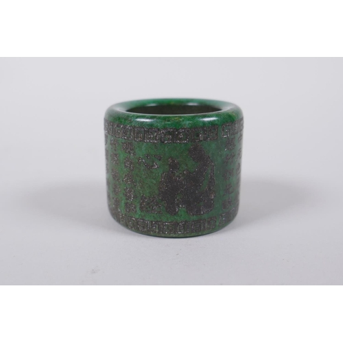 143 - A Chinese marbled green hardstone archers thumb ring, decorated with an allover character inscriptio... 