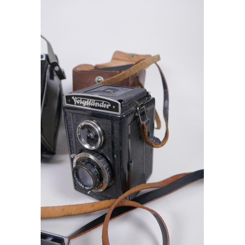 144 - Three vintage medium format film cameras including two Voigtlander Brilliant Compur and Lubitel 2, a... 