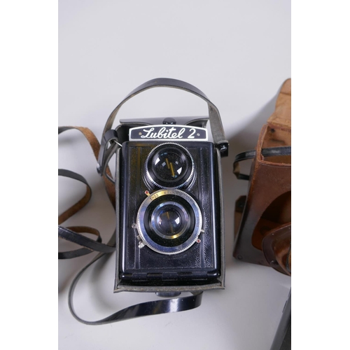 144 - Three vintage medium format film cameras including two Voigtlander Brilliant Compur and Lubitel 2, a... 