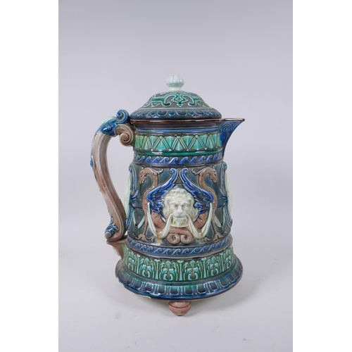 147 - A C19th continental Majolica jug and cover with lion mask decoration, signed and dated 1872 to the b... 