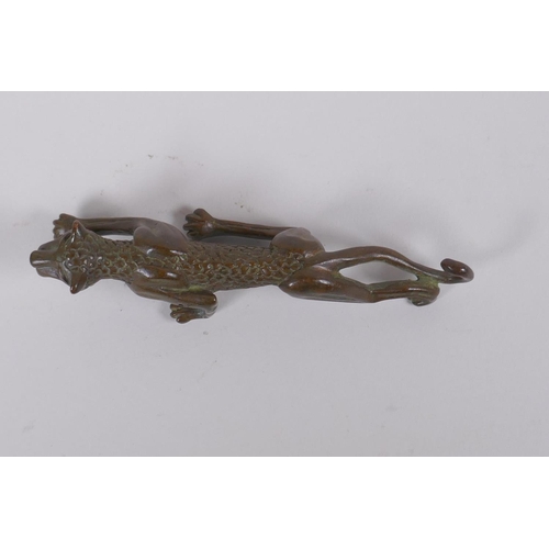 148 - A Japanese style bronze okimono in the form of a prowling leopard, 11cm long