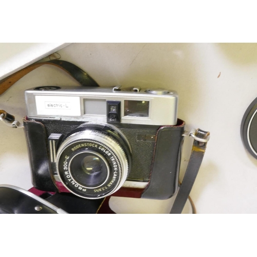 15 - A Pentax SP500 35mm SLR camera, telefoto lens and another, a Dakora 35mm camera, a vintage Kodak No.... 