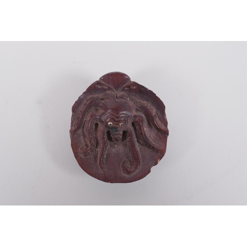 151 - A Japanese carved boxwood okimono in the form of an octopus in a clam shell, signed to base, 4 x 5cm