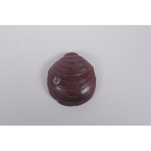 151 - A Japanese carved boxwood okimono in the form of an octopus in a clam shell, signed to base, 4 x 5cm