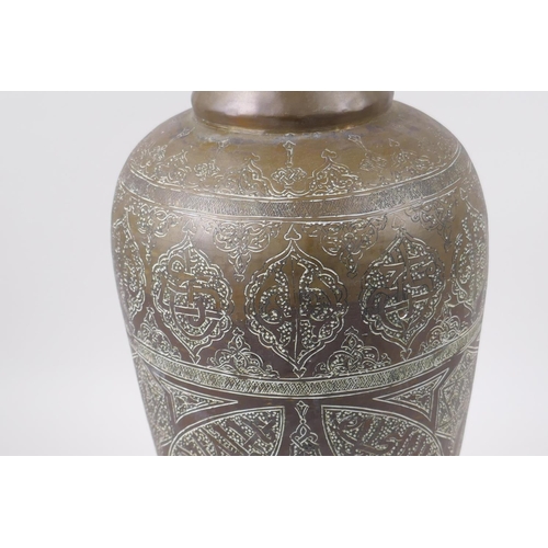 157 - An Islamic brass vase with chased script decoration, converted to a table lamp, 67cm high