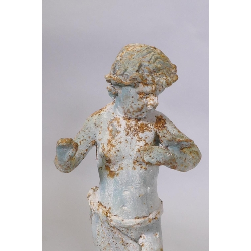 162 - A cast iron garden figure of putti, 49cm high