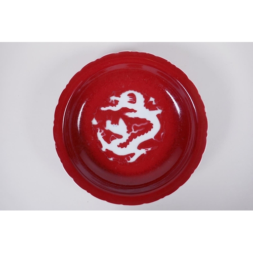 165 - A Chinese sang de boeuf glazed porcelain dish with lobed rim, decorated with a dragon to the bowl, X... 