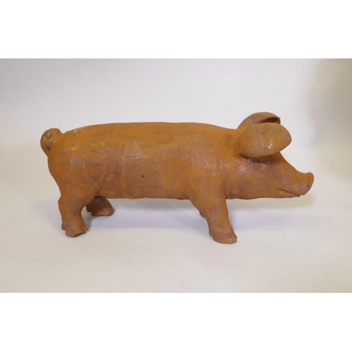 169 - A cast iron piglet, 43cm long