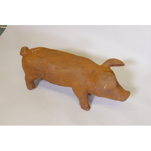 169 - A cast iron piglet, 43cm long