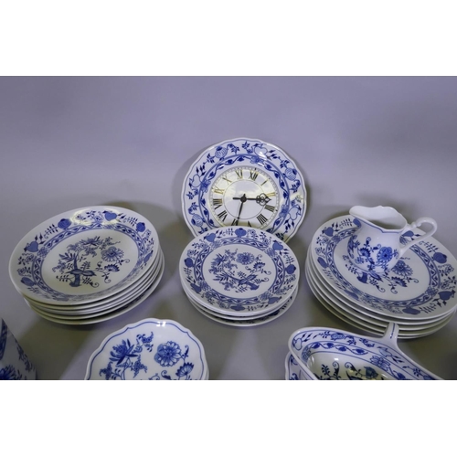 175 - A six place Bohemian matched onion pattern service with blue and white transfer painted decoration, ... 