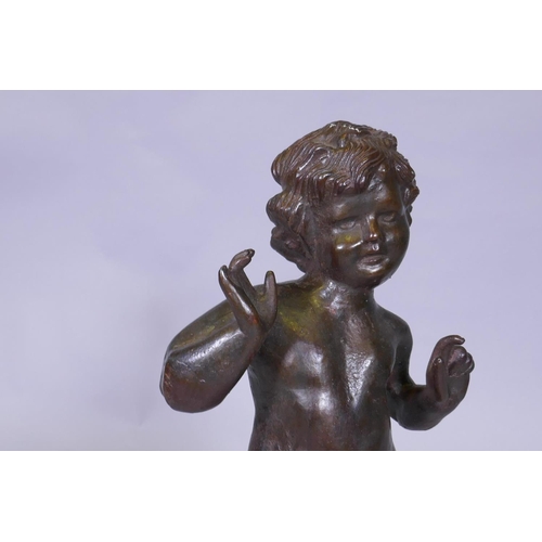 25 - A cast iron figure of a putto, 53cm high