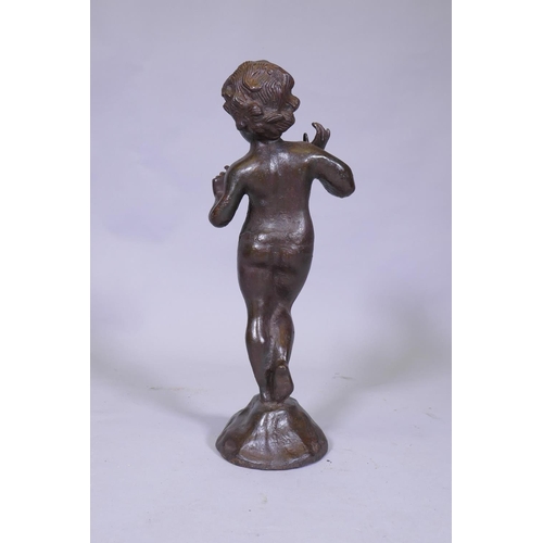 25 - A cast iron figure of a putto, 53cm high