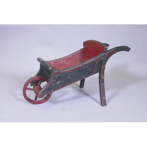 26 - A vintage painted pine child's wheel barrow, 72cm long, 36cm high