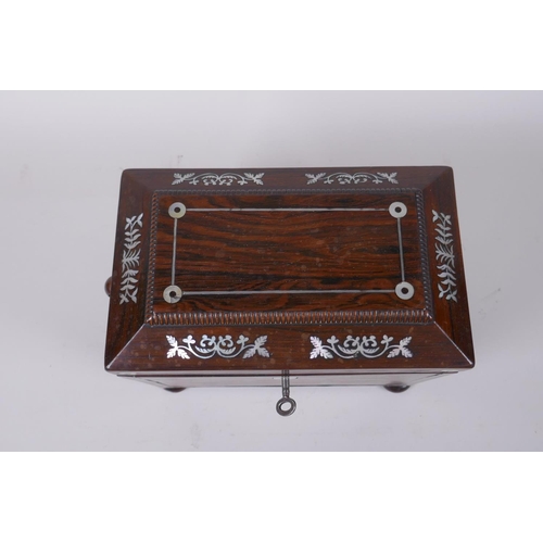 29 - A Victorian rosewood sarcophagus shaped tea caddy with silver and mother of pearl inlaid decoration,... 