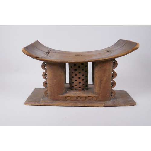 44 - An African Ashanti carved wood headrest/stool, first half of the C20th, repairs, 44 x 16cm, 24cm hig... 