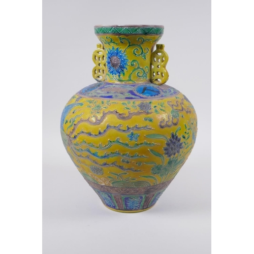 45 - A Chinese Fahua porcelain vase with two handles, decorated with a phoenix, dragon and flowers in the... 