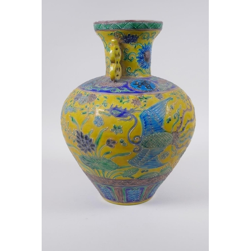 45 - A Chinese Fahua porcelain vase with two handles, decorated with a phoenix, dragon and flowers in the... 