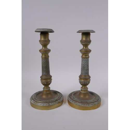 49 - A pair of brass candlesticks with machined decoration, 25cm high