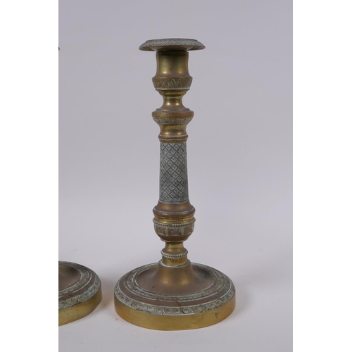 49 - A pair of brass candlesticks with machined decoration, 25cm high