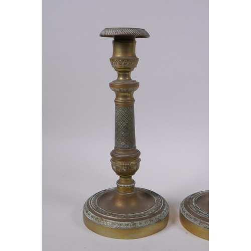 49 - A pair of brass candlesticks with machined decoration, 25cm high