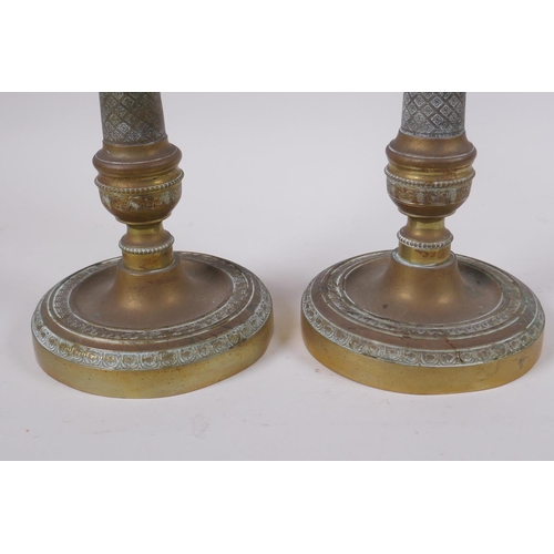 49 - A pair of brass candlesticks with machined decoration, 25cm high