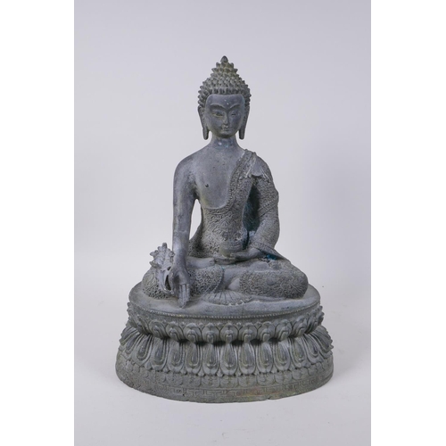 52 - A Tibetan bronze figure of Buddha seated on a lotus throne with verdigris patination, 35cm high