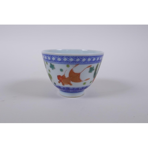 70 - A blue and white porcelain tea bowl with iron red goldfish decoration, Chinese Dao Guang seal mark t... 