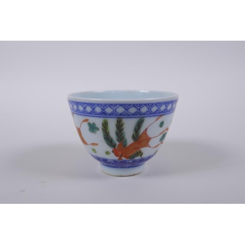 70 - A blue and white porcelain tea bowl with iron red goldfish decoration, Chinese Dao Guang seal mark t... 