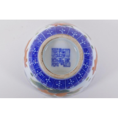 70 - A blue and white porcelain tea bowl with iron red goldfish decoration, Chinese Dao Guang seal mark t... 