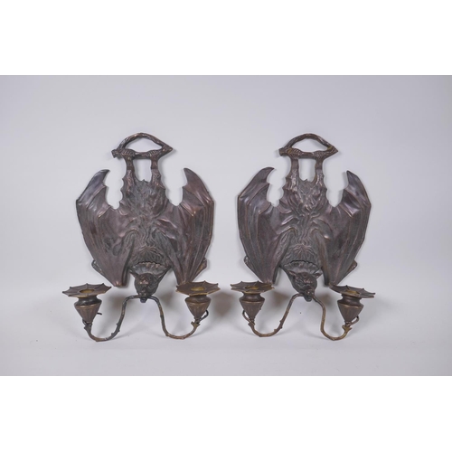 81 - A pair of gothic style bronze two branch wall sconces in the form of bats, 24 x 33cm