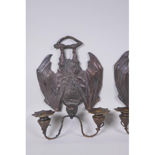 81 - A pair of gothic style bronze two branch wall sconces in the form of bats, 24 x 33cm