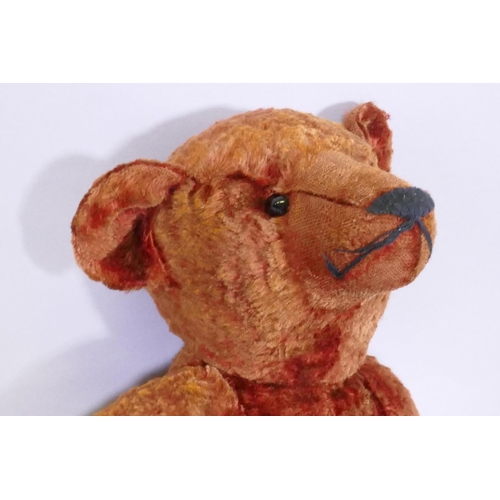 9 - An antique red plush hump back teddy bear, 46cm long