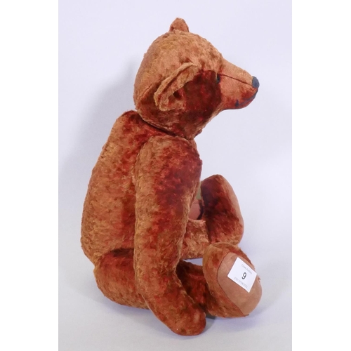 9 - An antique red plush hump back teddy bear, 46cm long