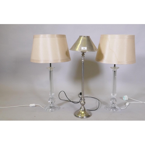 94 - A pair of lucite/acrylic table lamps, 68cm high with shade, and a brushed metal lamp and shade