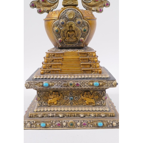 95 - A Tibetan bronze stupa with gilt and silvered highlights and set with semi precious stones, 33cm hig... 