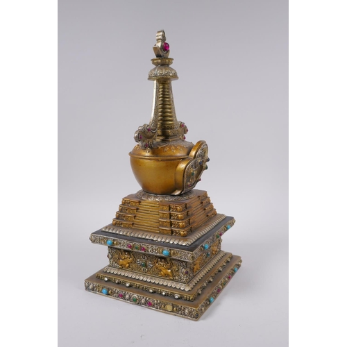 95 - A Tibetan bronze stupa with gilt and silvered highlights and set with semi precious stones, 33cm hig... 