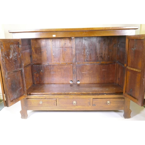 1136 - A Chinese hardwood cabinet with brass mounts and folding doors, raised on shaped supports, 186 x 64 ... 