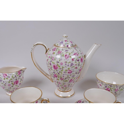 222 - An Arklow pottery six piece coffee set with a transfer printed rose decoration, one cup different, l... 