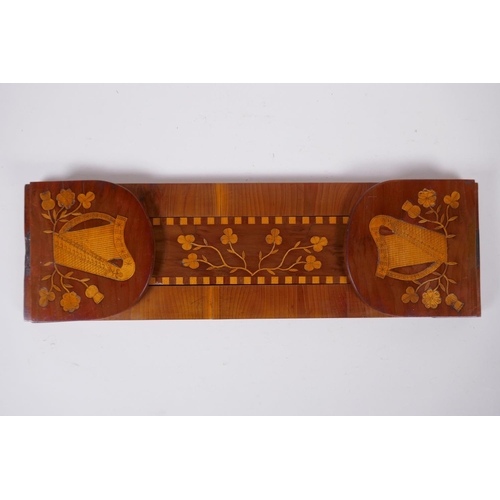 1 - A C19th Irish Kilarney satinwood inlaid yew wood book slide, decorated with harps and clover