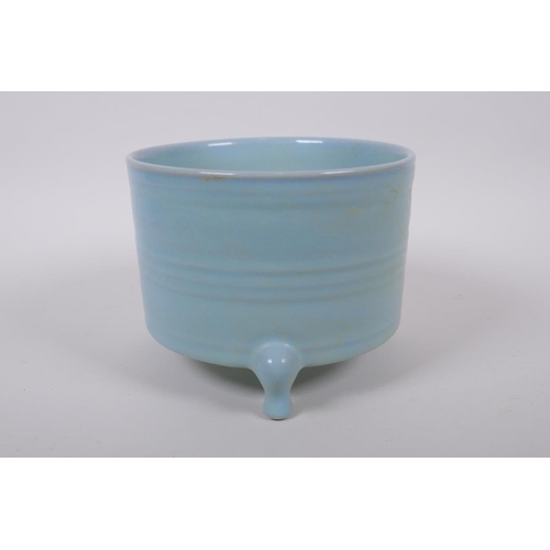 100 - A Chinese Ru ware style porcelain cylinder censer on tripod supports, 17cm diameter