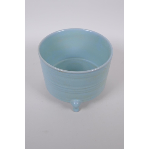 100 - A Chinese Ru ware style porcelain cylinder censer on tripod supports, 17cm diameter