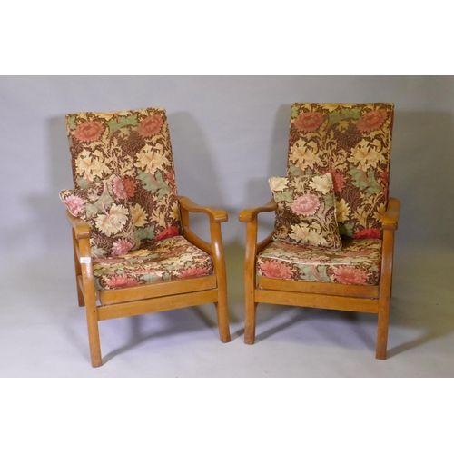 1012 - A pair of mid century beechwood reclining open arm chairs