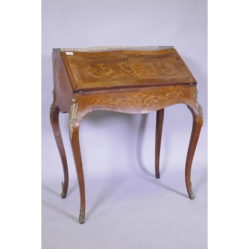 1015 - A C19th continental marquetry inlaid tulipwood and rosewood bonheure de jour, with pierced brass gal... 