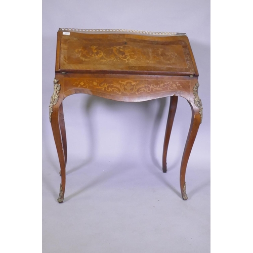 1015 - A C19th continental marquetry inlaid tulipwood and rosewood bonheure de jour, with pierced brass gal... 