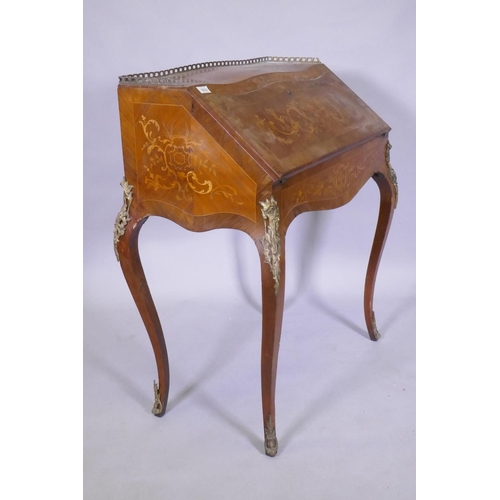 1015 - A C19th continental marquetry inlaid tulipwood and rosewood bonheure de jour, with pierced brass gal... 