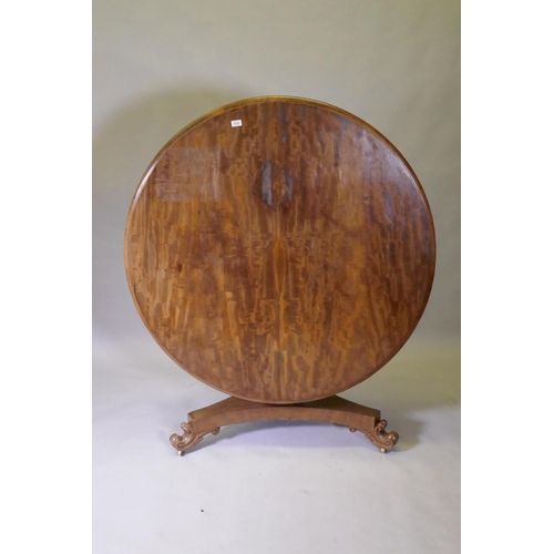 1016 - A C19th mahogany tilt top breakfast table, raised on a shaped column and tri-form platform base with... 