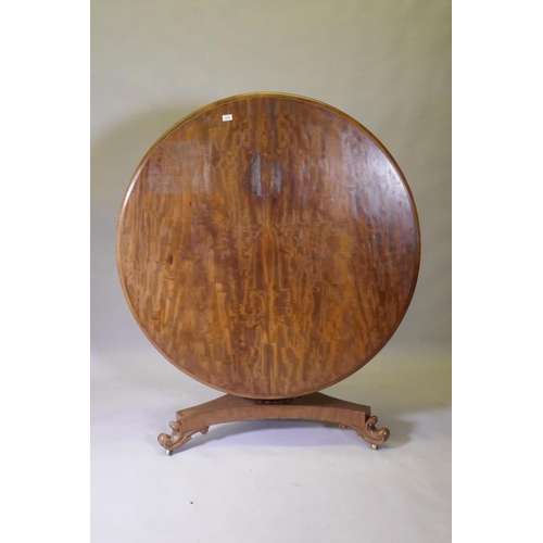 1016 - A C19th mahogany tilt top breakfast table, raised on a shaped column and tri-form platform base with... 